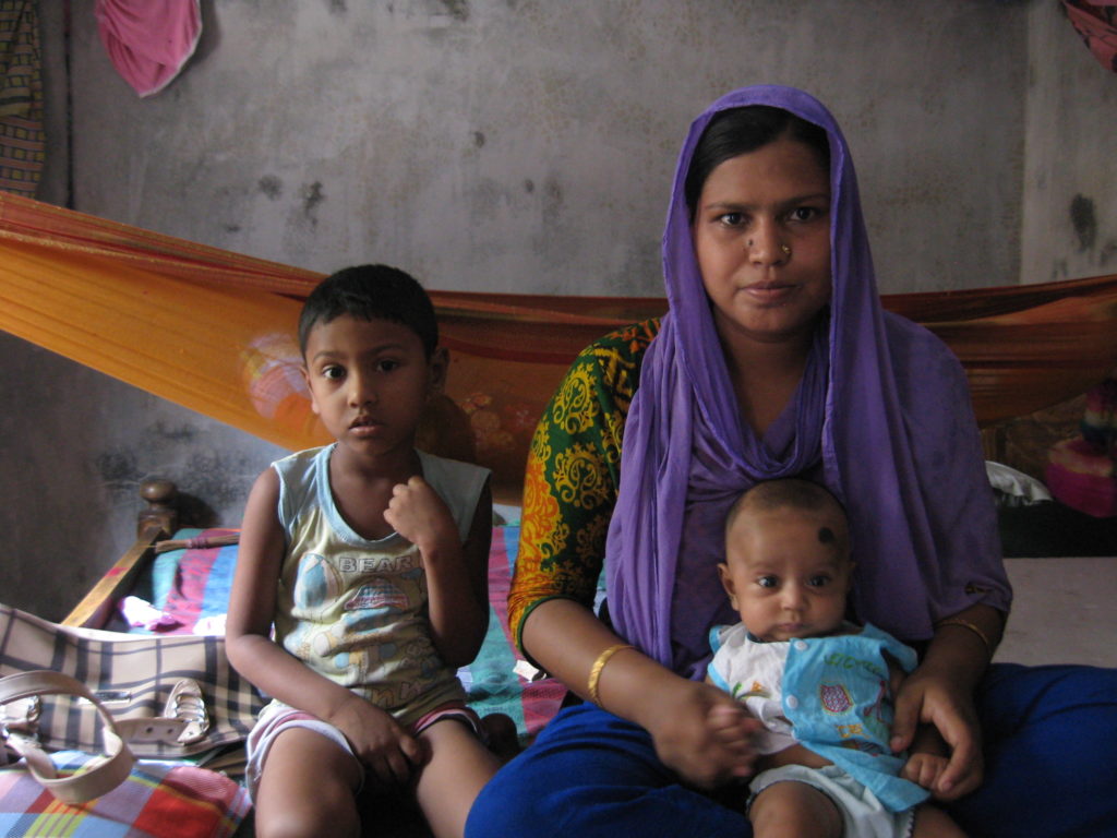 Shamima and her children in her home in southwestern Bangladesh