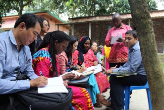 Opens popup gallery with Zaw, Wigayi, Thi Thi, Fatima, Myo Su and Jovin speaking with legal trainers after a community domestic violence training in Manikanj.