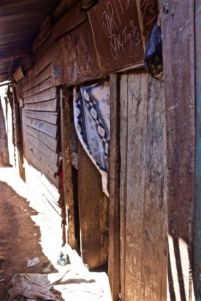 Opens popup gallery with The entrance to Khadija Hamsa's house. The chalk numbers are the closest Kibera comes to addresses.